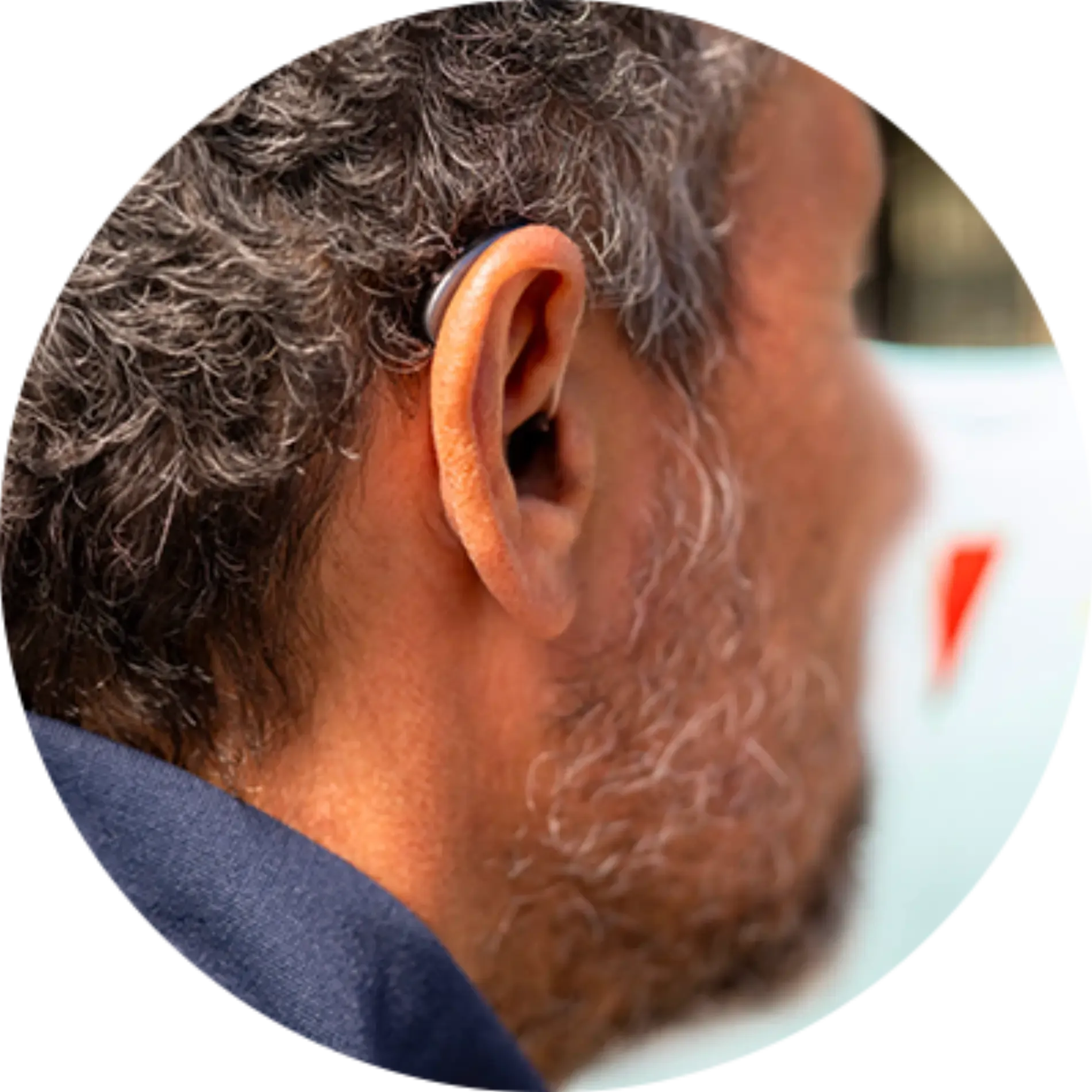 A man with a hearing aid in his left ear