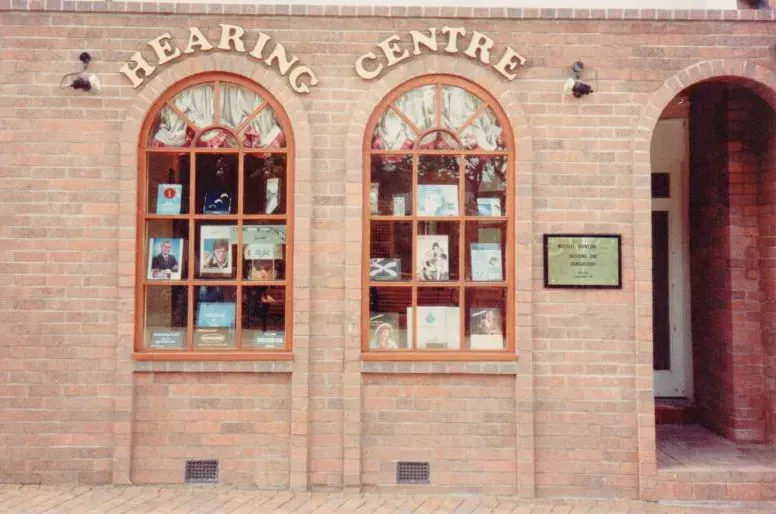 The front of a hearing centre with arched windows