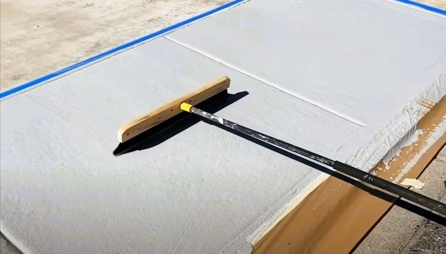 Squeegee tool on freshly resurfaced concrete