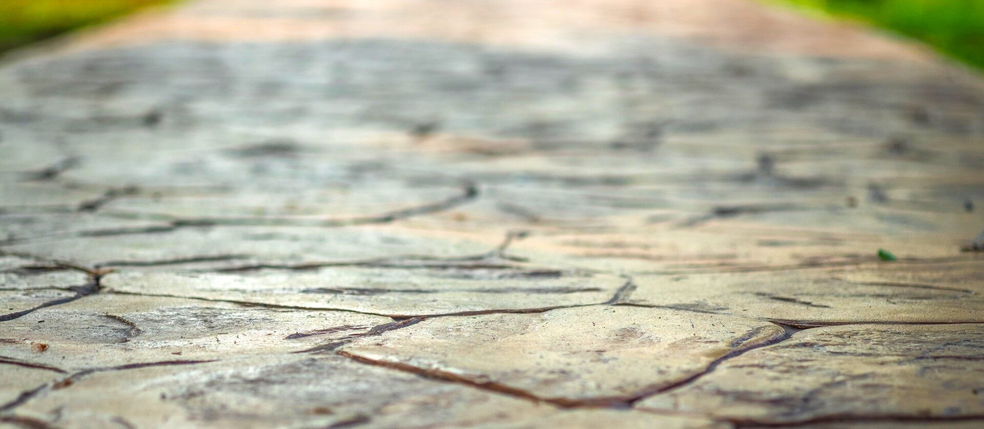 A walkway that's made of stamped concrete with a flagstone pattern.