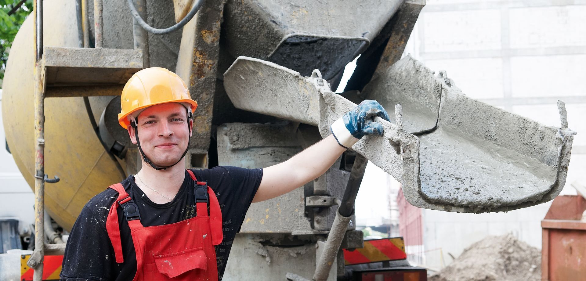 concrete contractor standing next to concrete truck