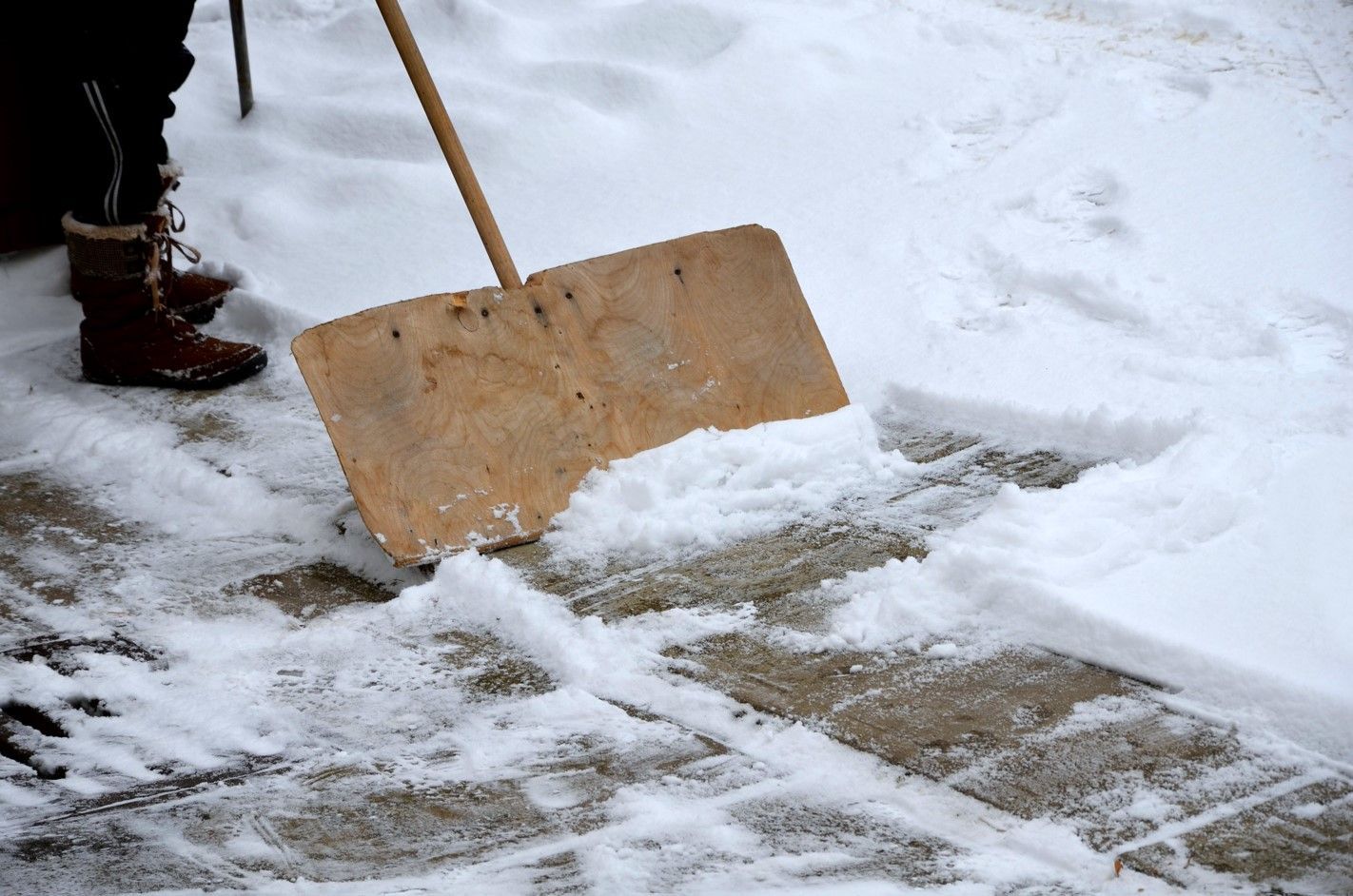 Ice shoveling for concrete maintenance at a home in Holland, MI