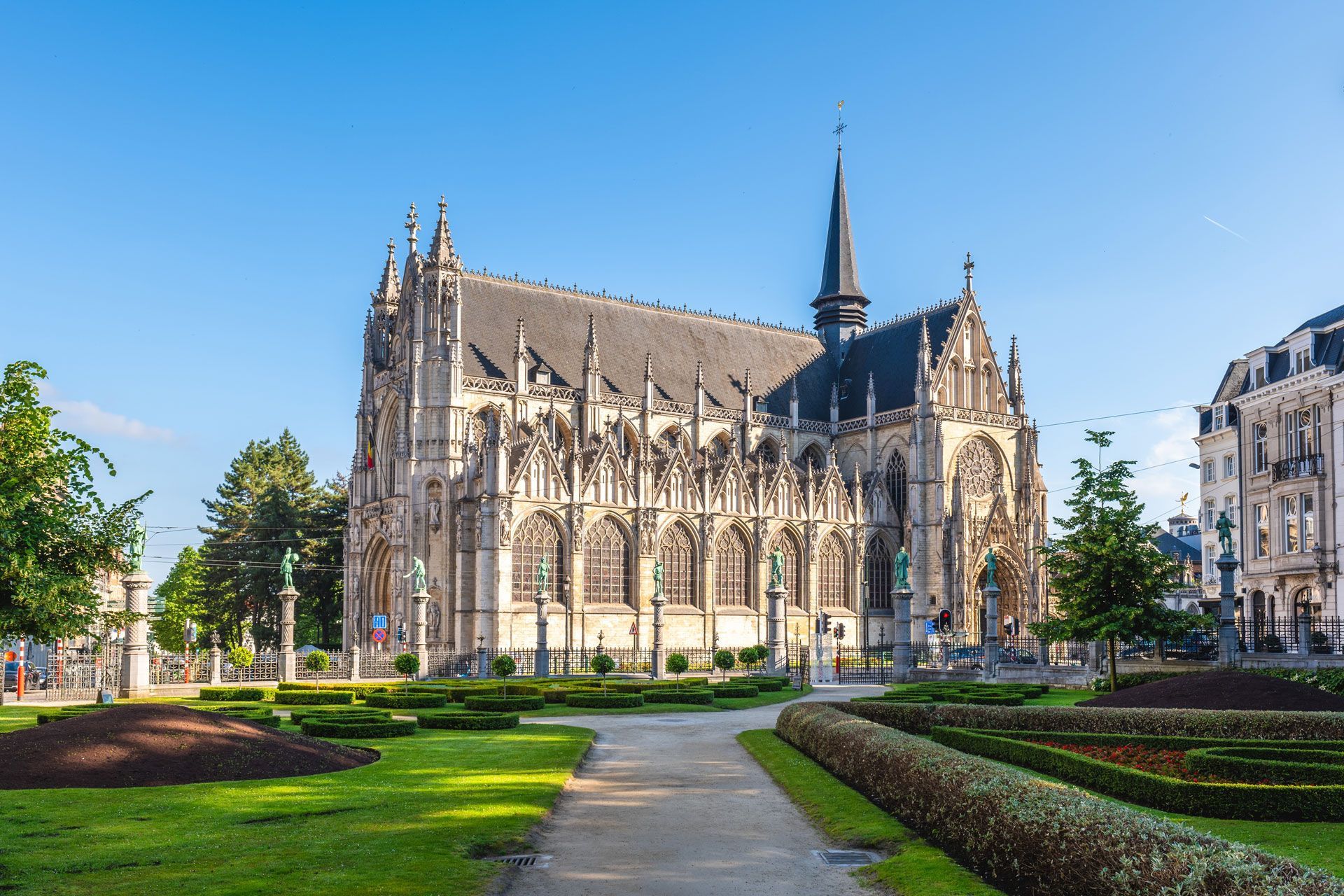 There is a large church with a steeple in the middle of a park.