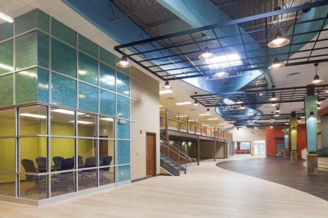 A large room with a lot of windows and chairs.