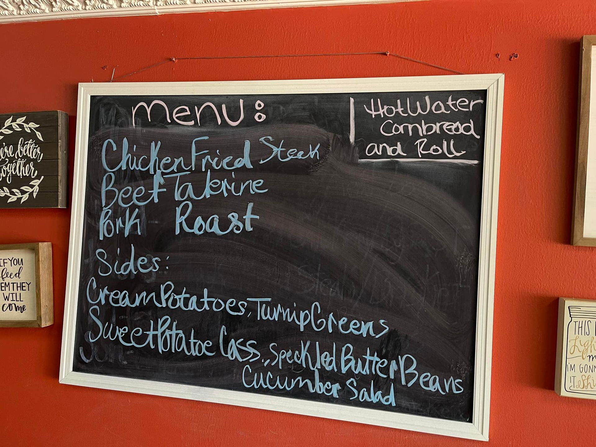 Menu on a chalkboard: chicken fried steak, sides, hot water cornbread, and rolls.