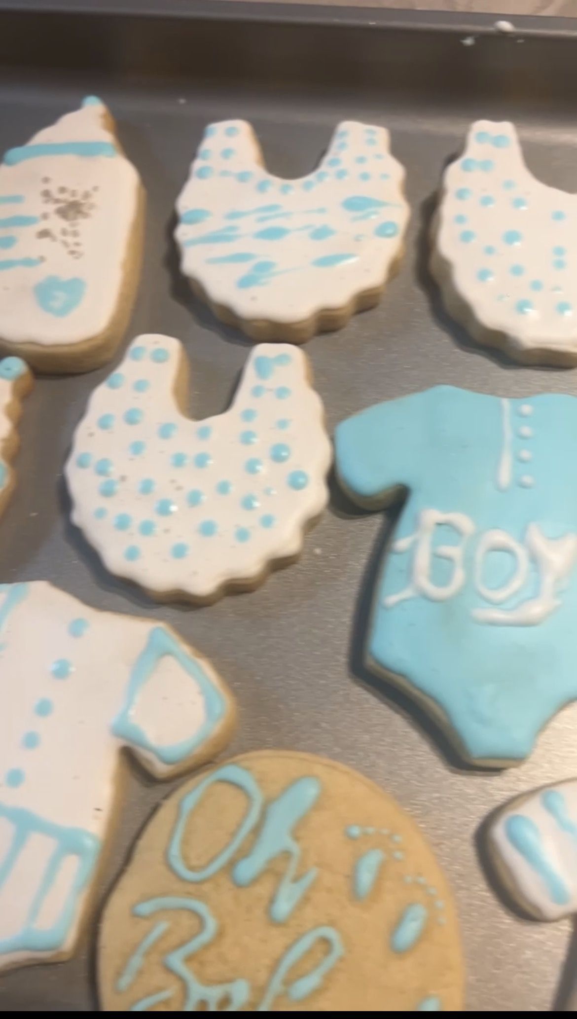 A tray of cookies decorated for a baby shower for a boy