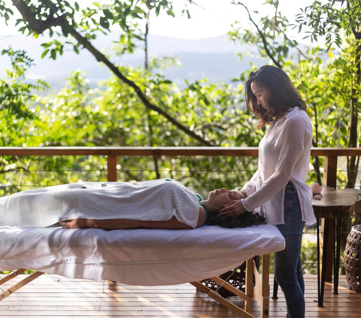 A woman is holding a tablet in her hand and smiling.