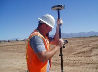 Man Holding Survey Stake - Surveying in Phoenix, AZ