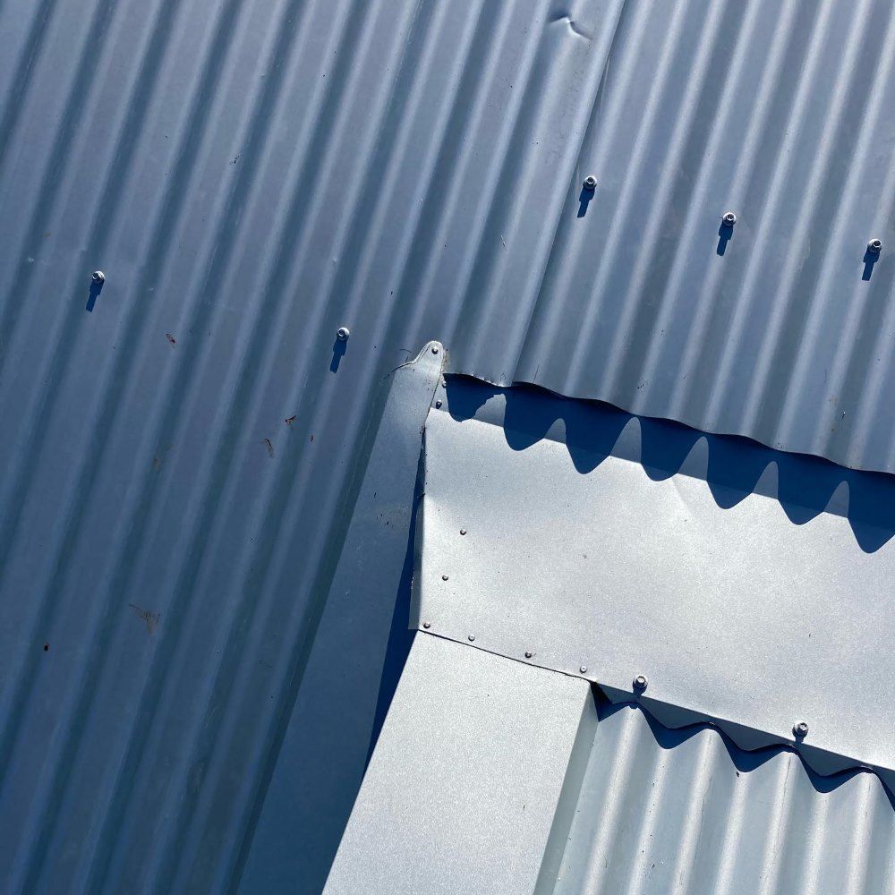 A Close Up of a Blue Corrugated Metal Roof — Richmond River Roofing Pty Ltd in East Ballina, NSW