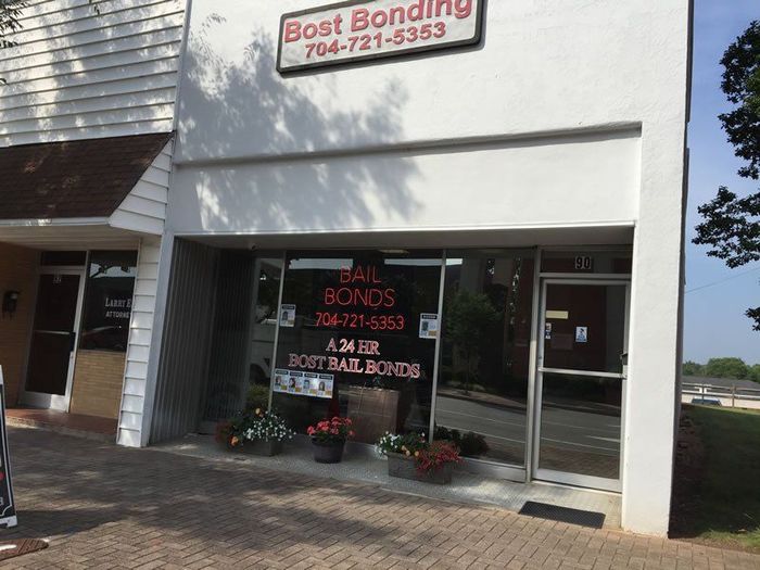 A white building with a sign that says best bonding