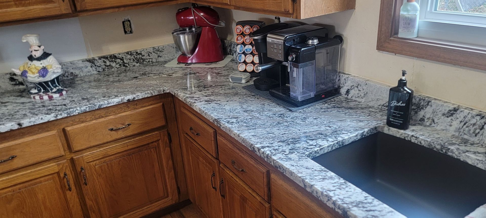 A kitchen with granite counter tops and a sink.