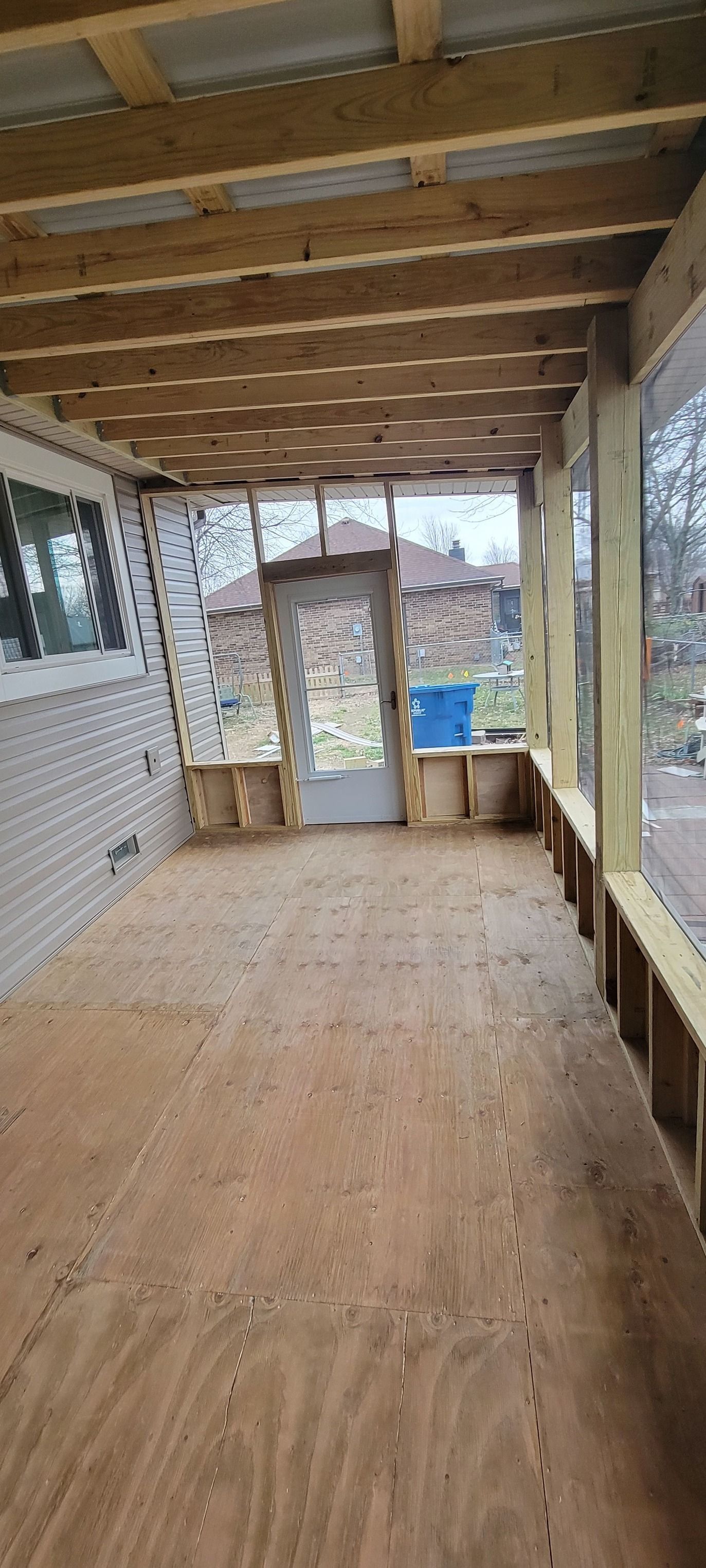 An empty room with a wooden floor and a door.