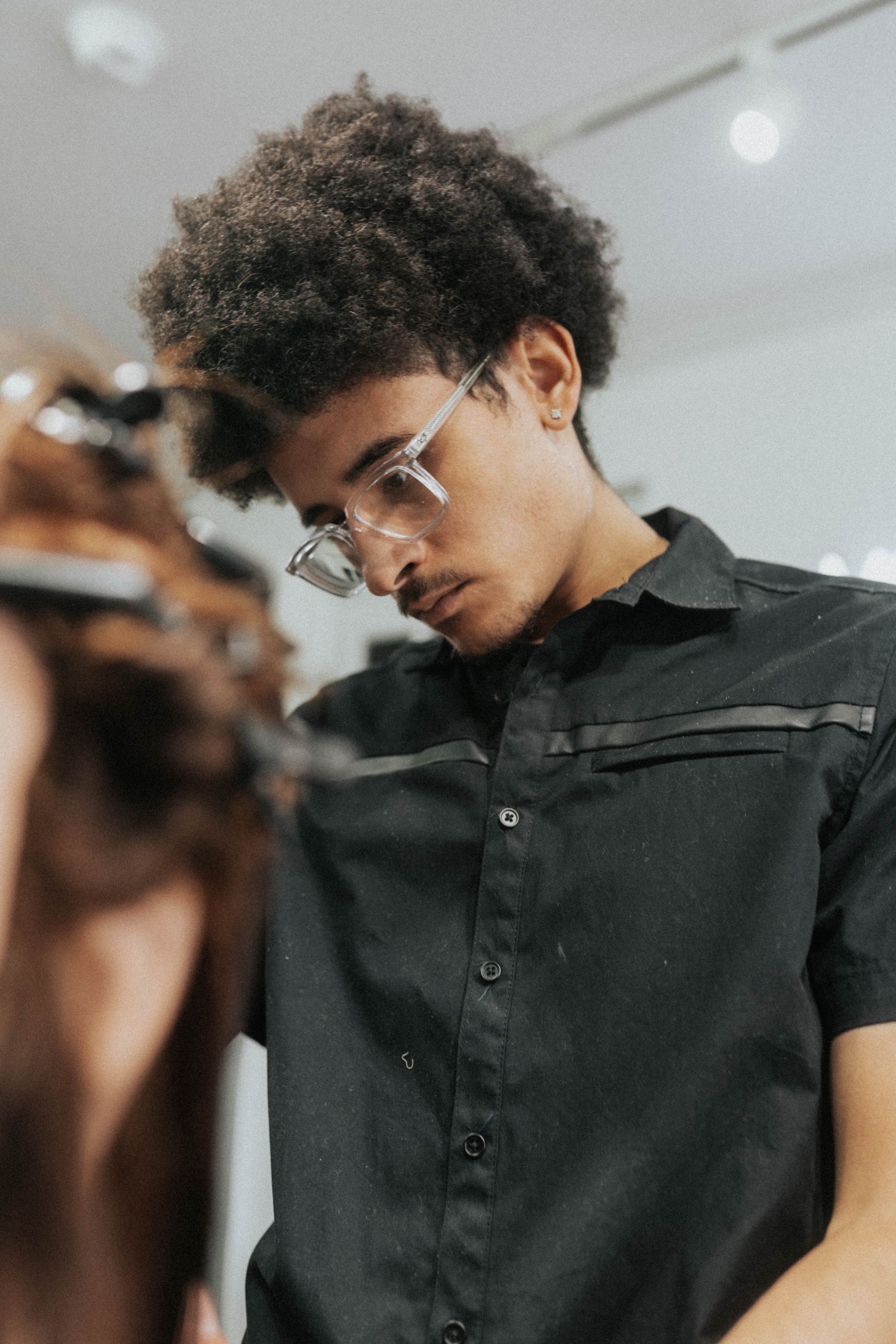 Barber focused on client haircut at The Modern Man Barber Studio in Long Branch NJ.
