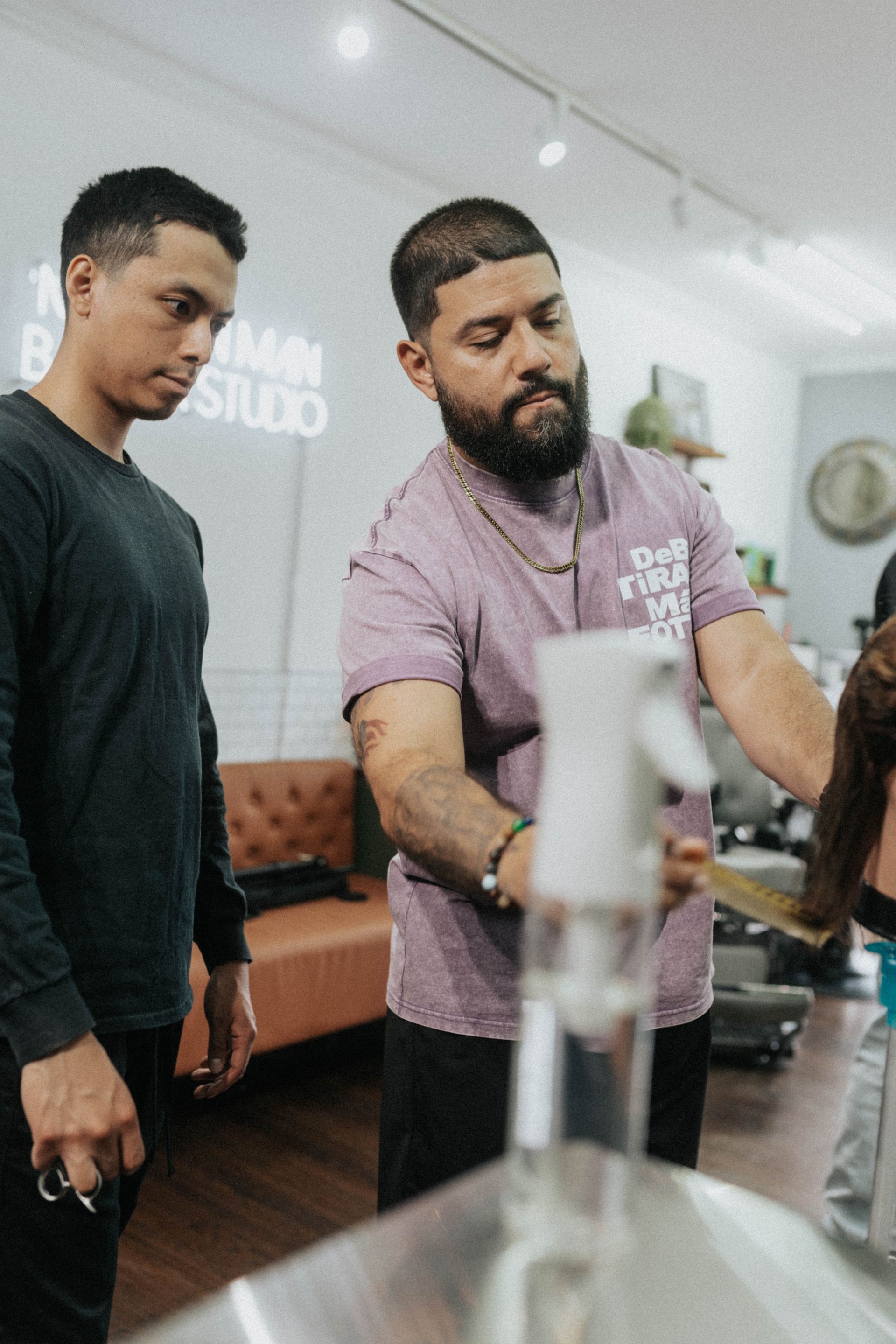 Barber gives a precise haircut at a barbershop in Long Branch NJ.