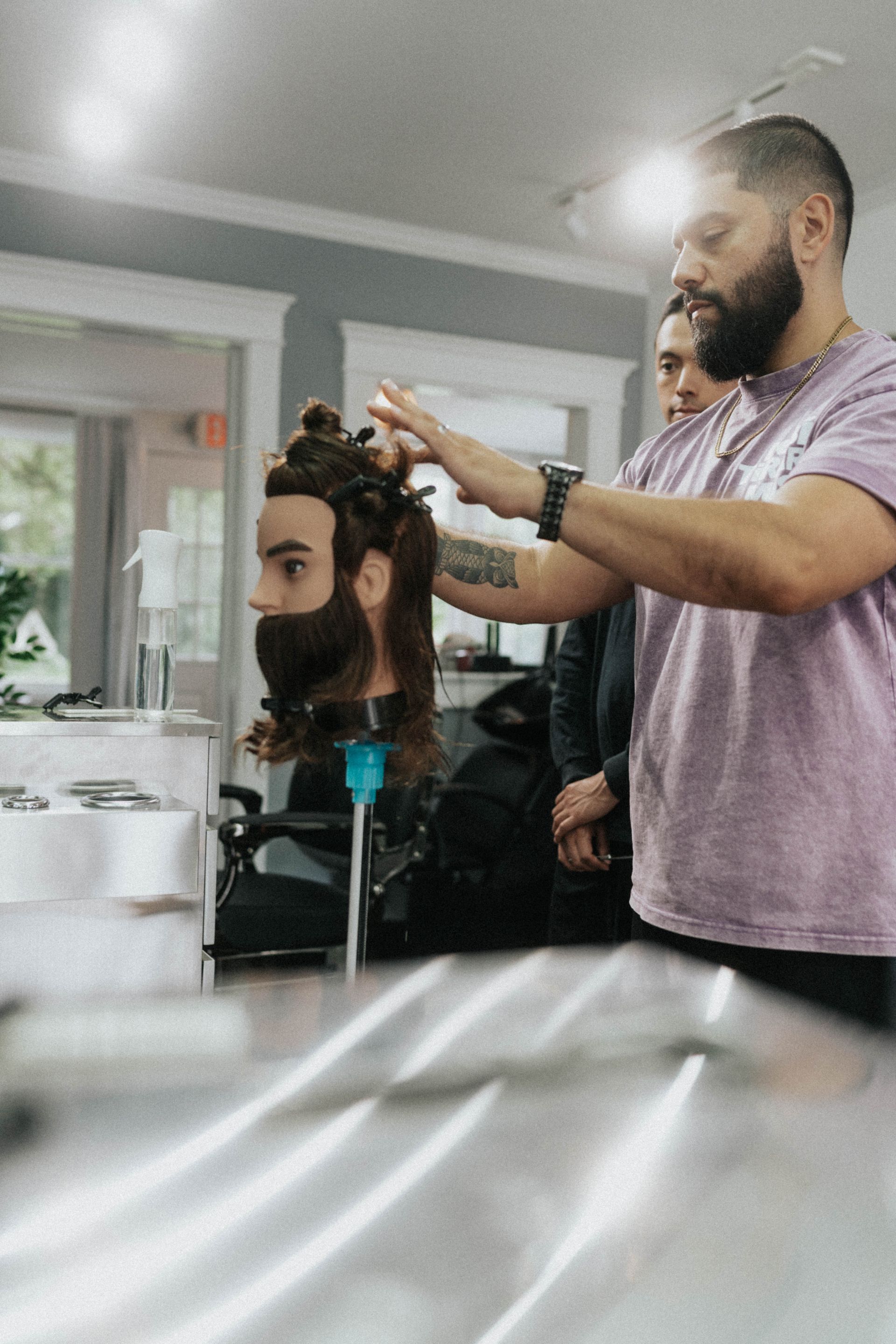 Barber shaping a clients beard and haircut at Modern Man Barber Studio in Long Branch, NJ for a sharper look