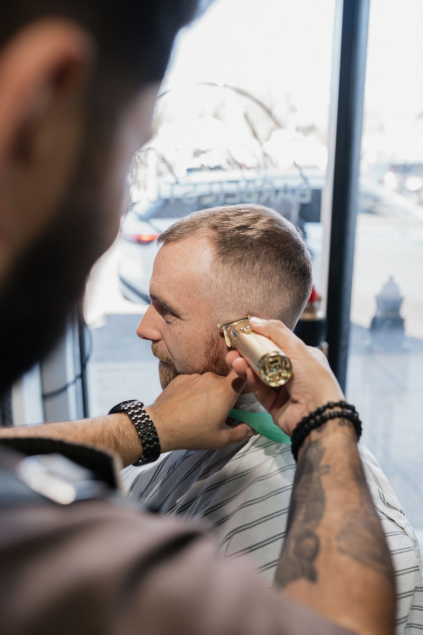 Client getting a modern fade and beard lineup at Modern Man Barber Studio in Long Branch, NJ for a confident finish