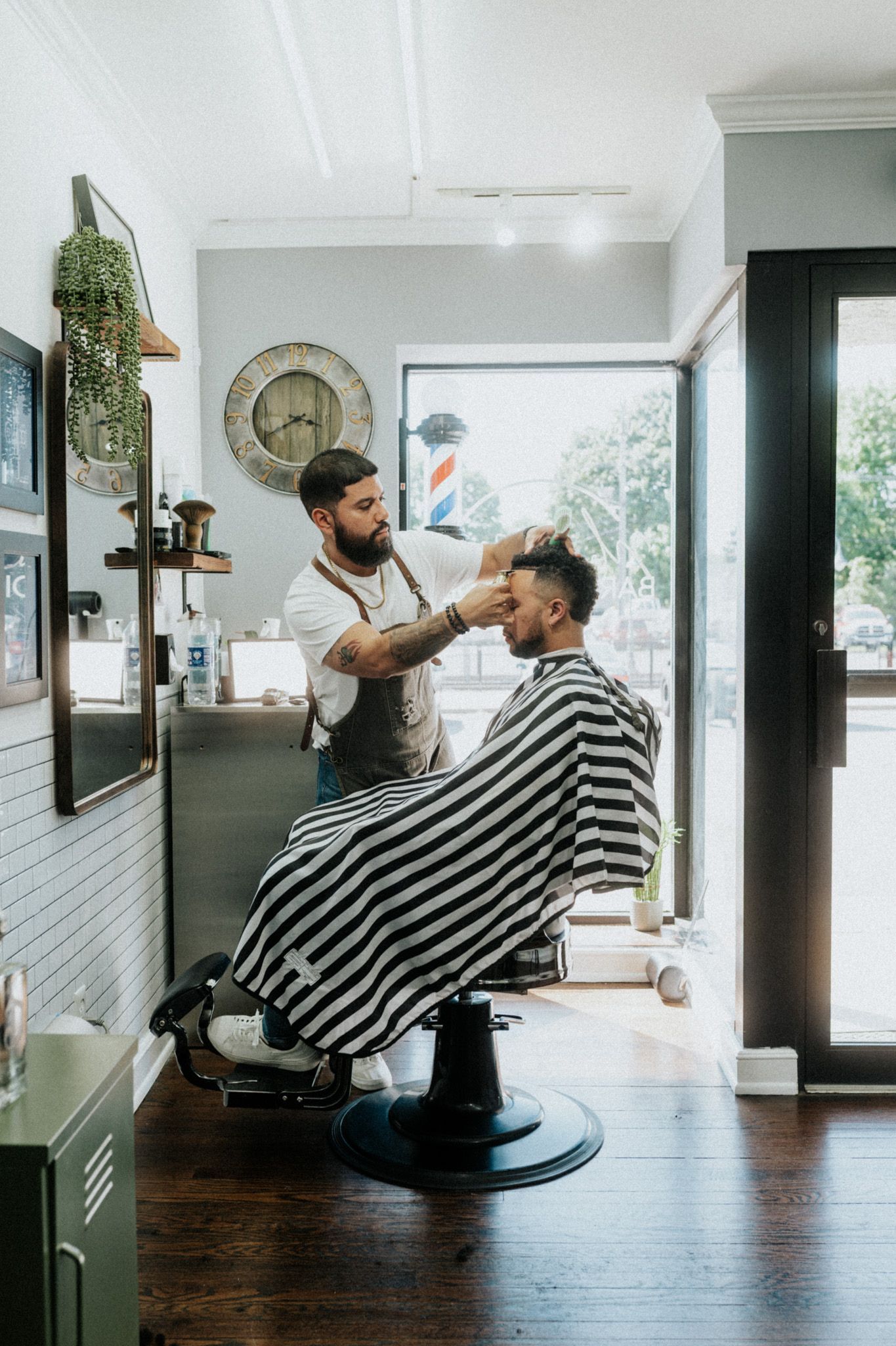 Barber giving a fresh men’s haircut at a barbershop in Long Branch NJ, offering expert grooming.