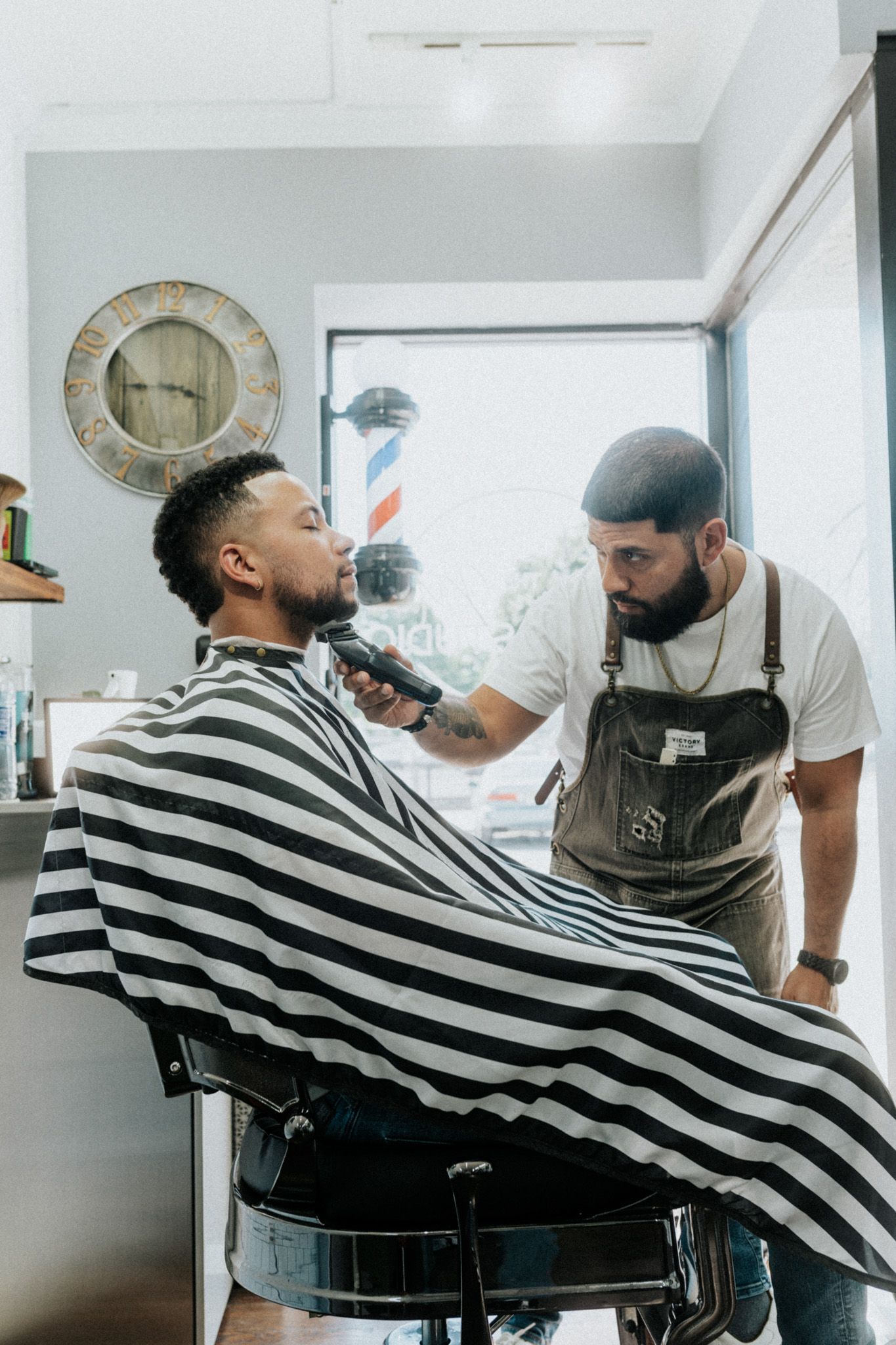 Barber trims a client’s beard at The Modern Man Barber Studio in Long Branch NJ.