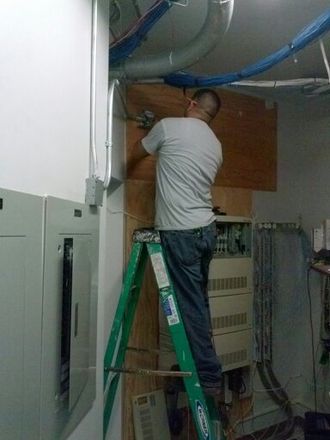 Circuit rewiring and repairs — Man fixing solar panel in Chino Hills, CA