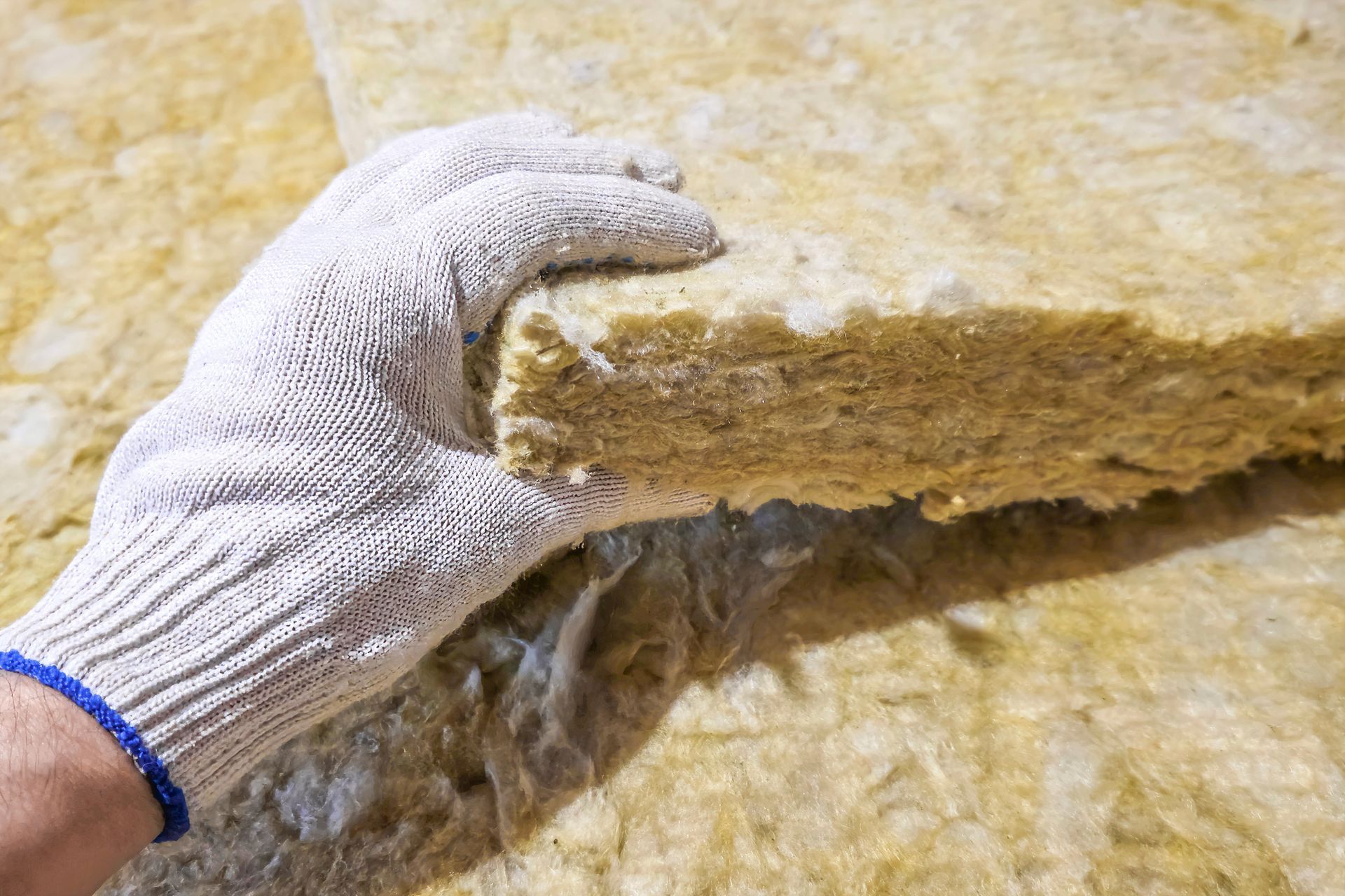 fiber glass being held with protective glove
