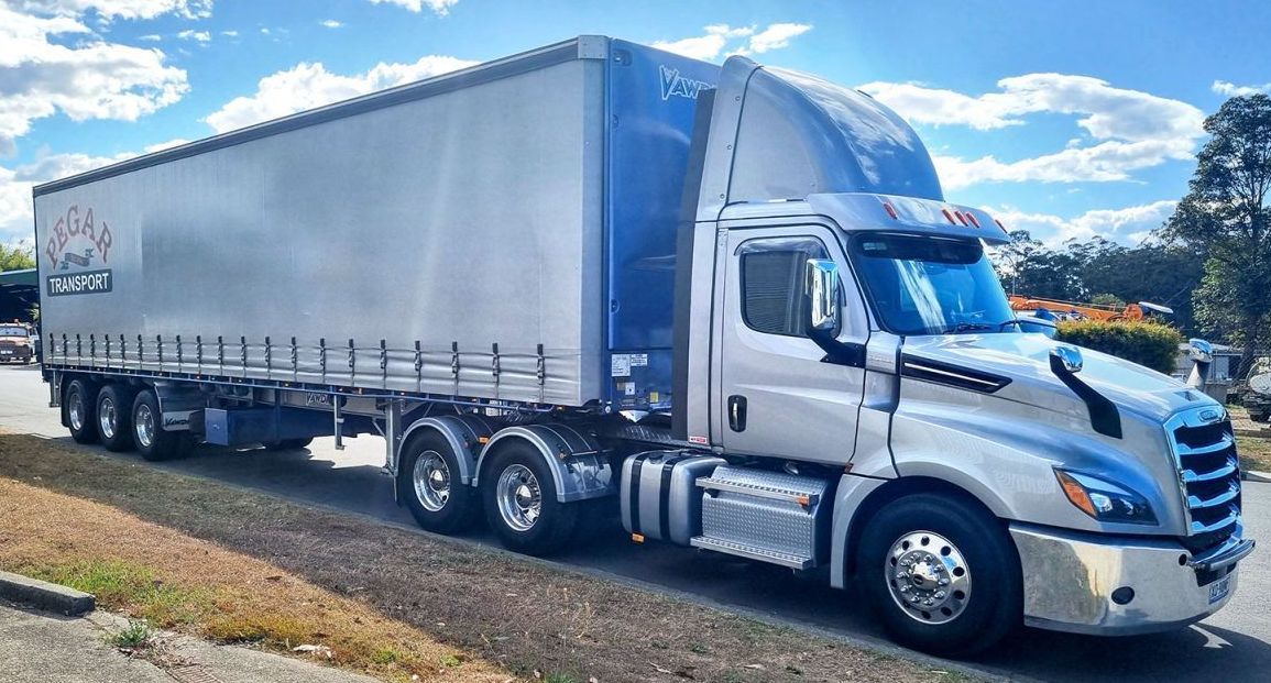 A Large Semi Truck Is Parked On The Side Of The Road — Pegar Transport In Port Macquarie, NSW