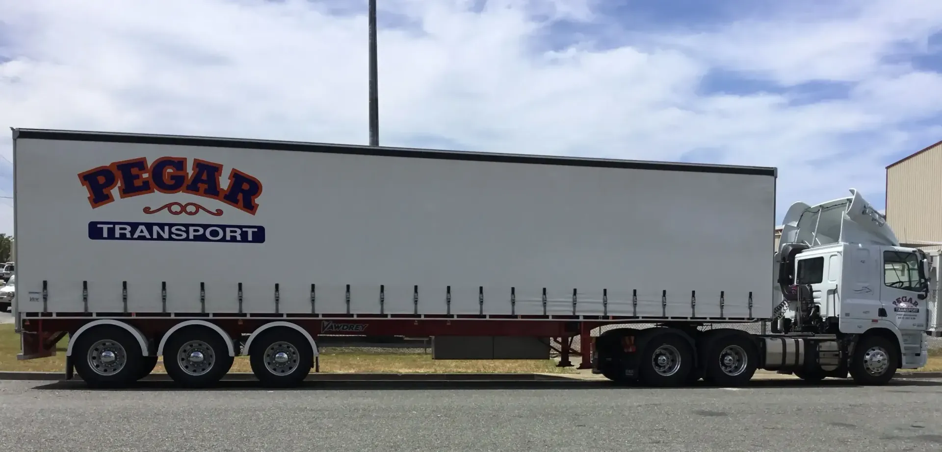 Two Delivery Men Are Standing Next To A White Van Filled With Boxes — Pegar Transport In Newcastle, NSW
