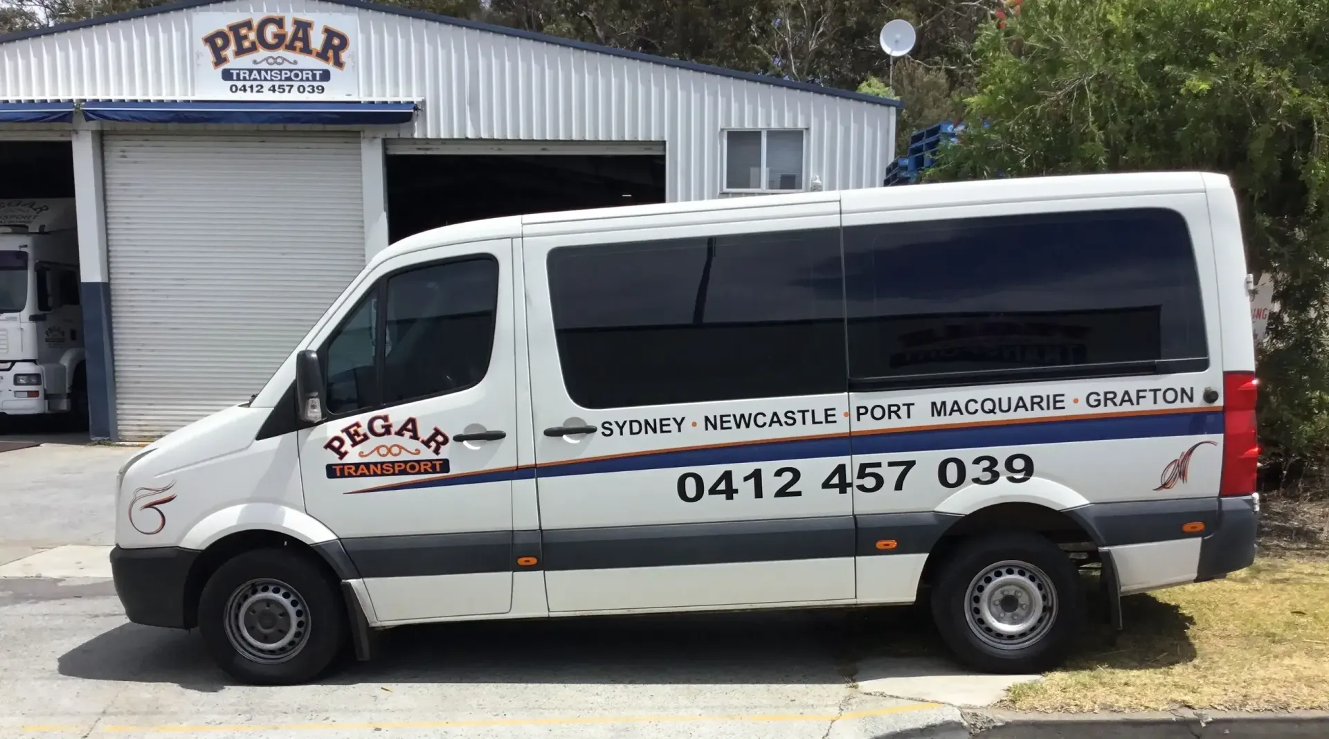A Row Of Trucks Are Parked In A Parking Lot In Front Of Shipping Containers — Pegar Transport In Sydney, NSW