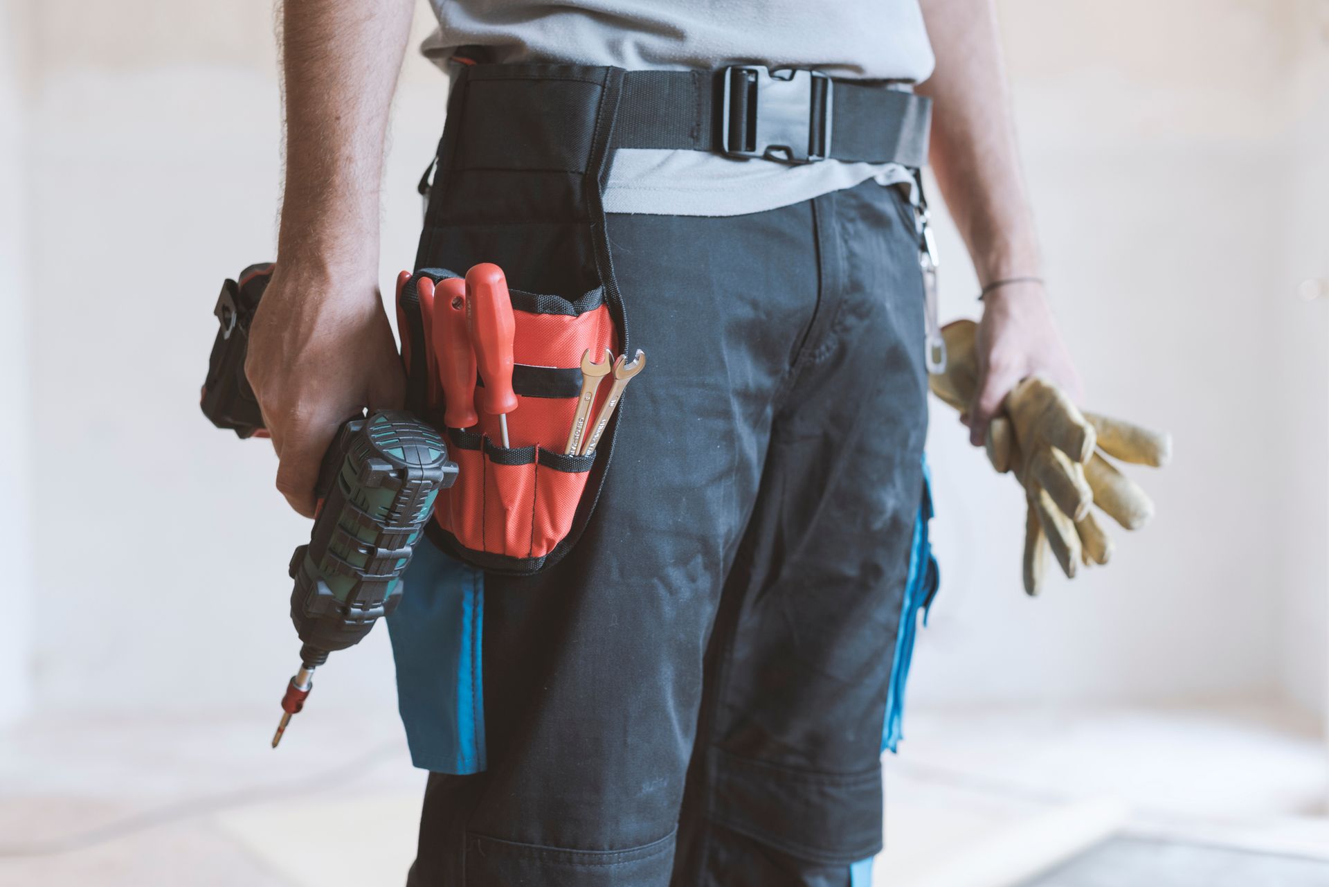 A person holding a tool belt