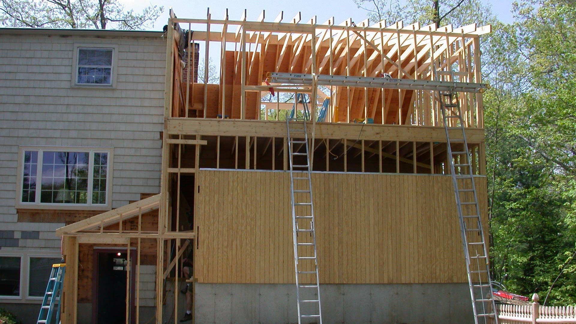 A house under construction with a ladder on the side