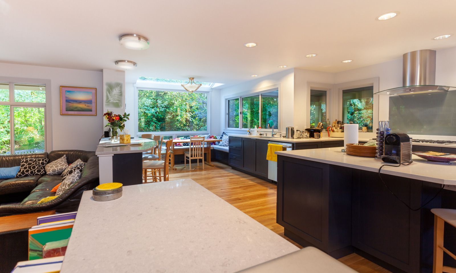 A kitchen and dining room in a house with a lot of windows.