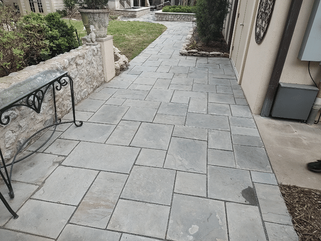 A Patio with a Table and Chairs on it in front of a House - Tulsa, OK - Outdoor Orchestrators