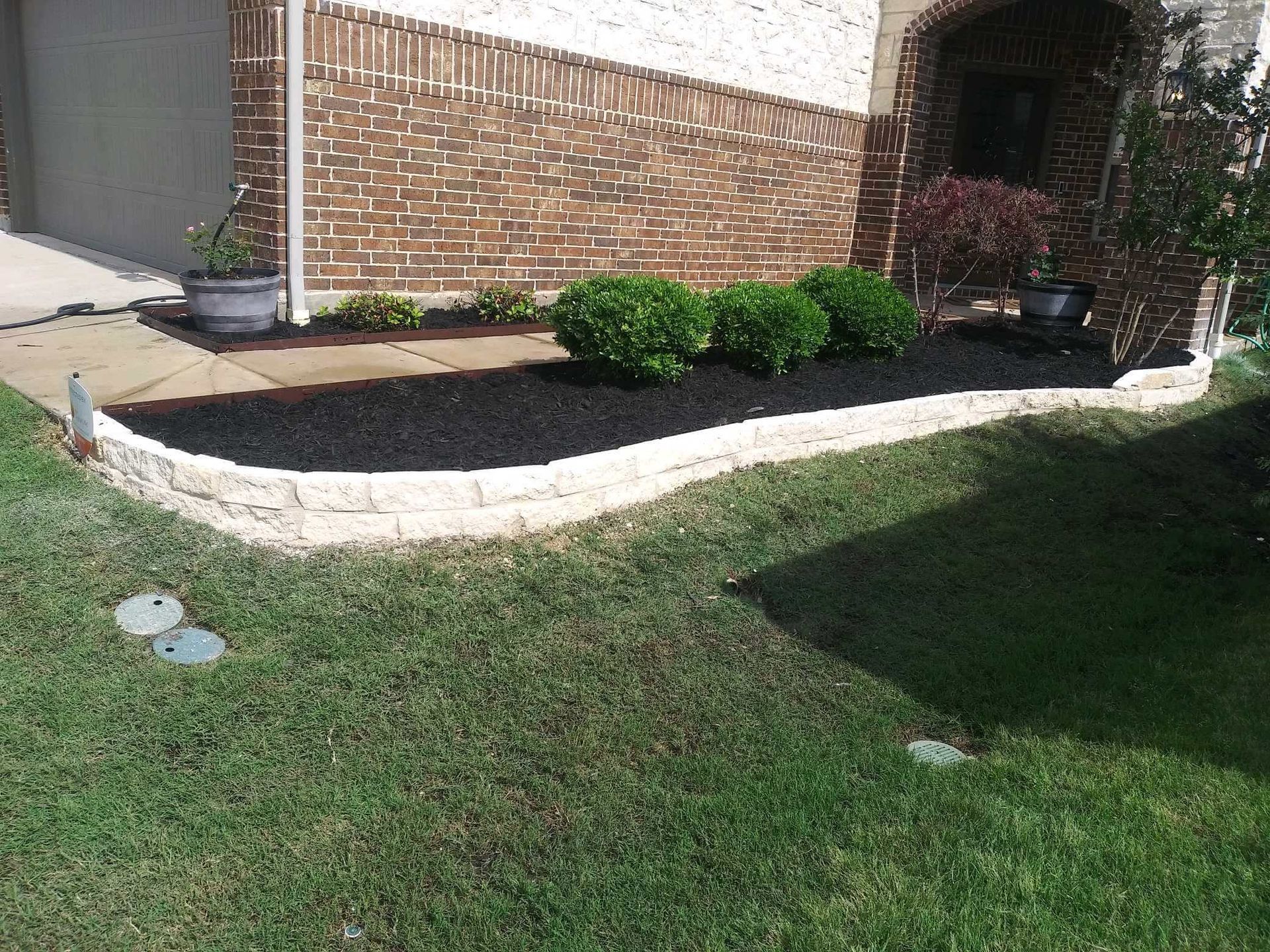 A Brick House with a lush green Lawn - Tulsa, OK - Outdoor Orchestrators