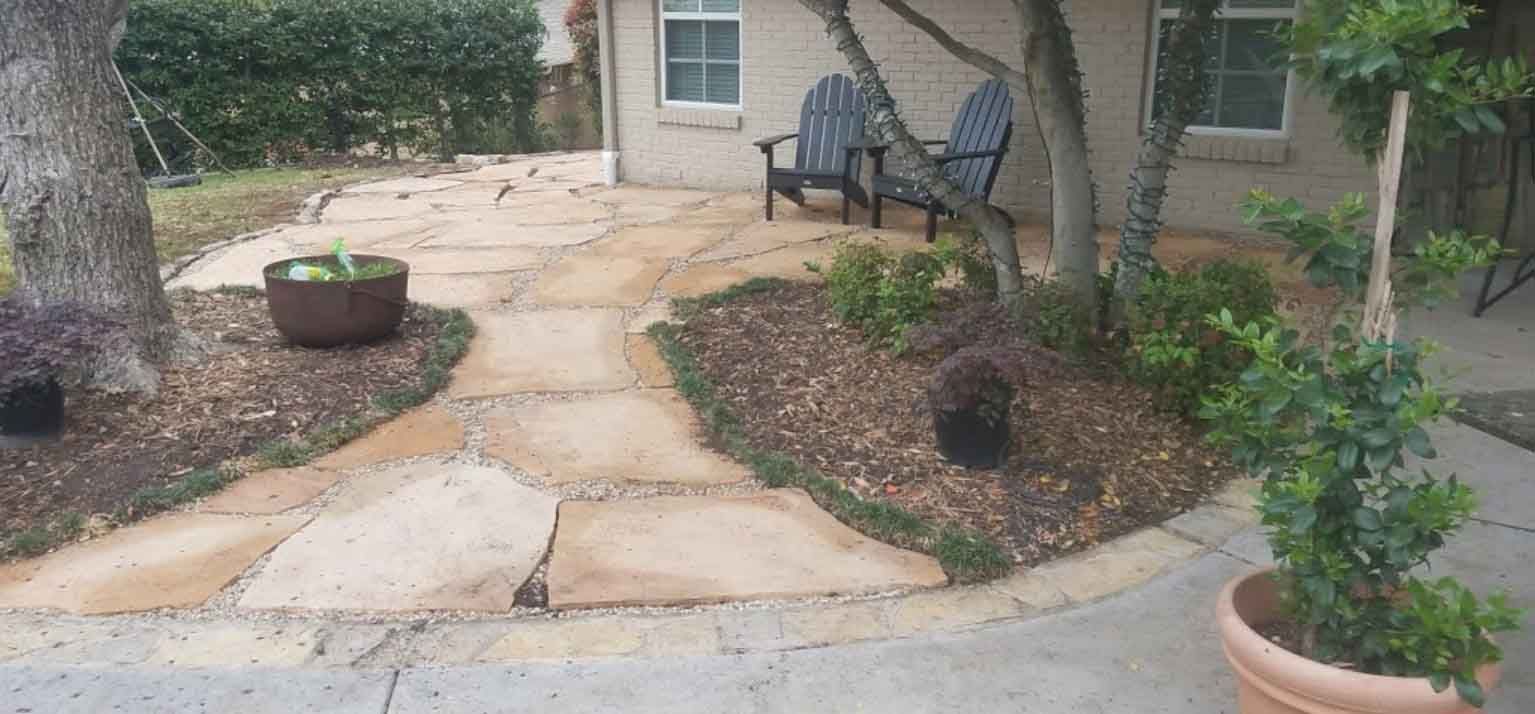 A Patio with Two Chairs and a potted Plant in front of a House - Tulsa, OK - Outdoor Orchestrators