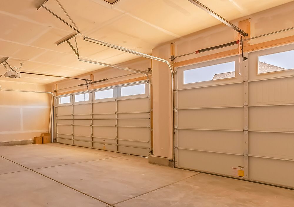 An empty garage with a lot of garage doors and windows.
