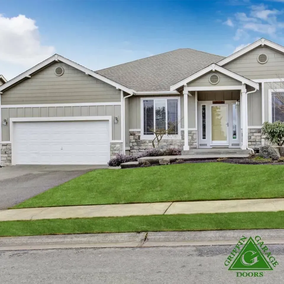 A house with a green garage doors logo on it