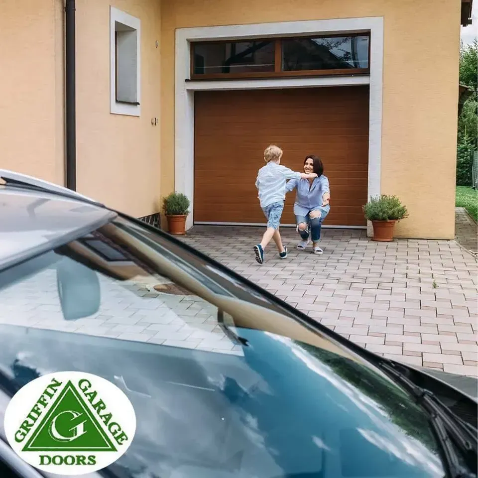 A griffin garage doors logo is on the windshield of a car