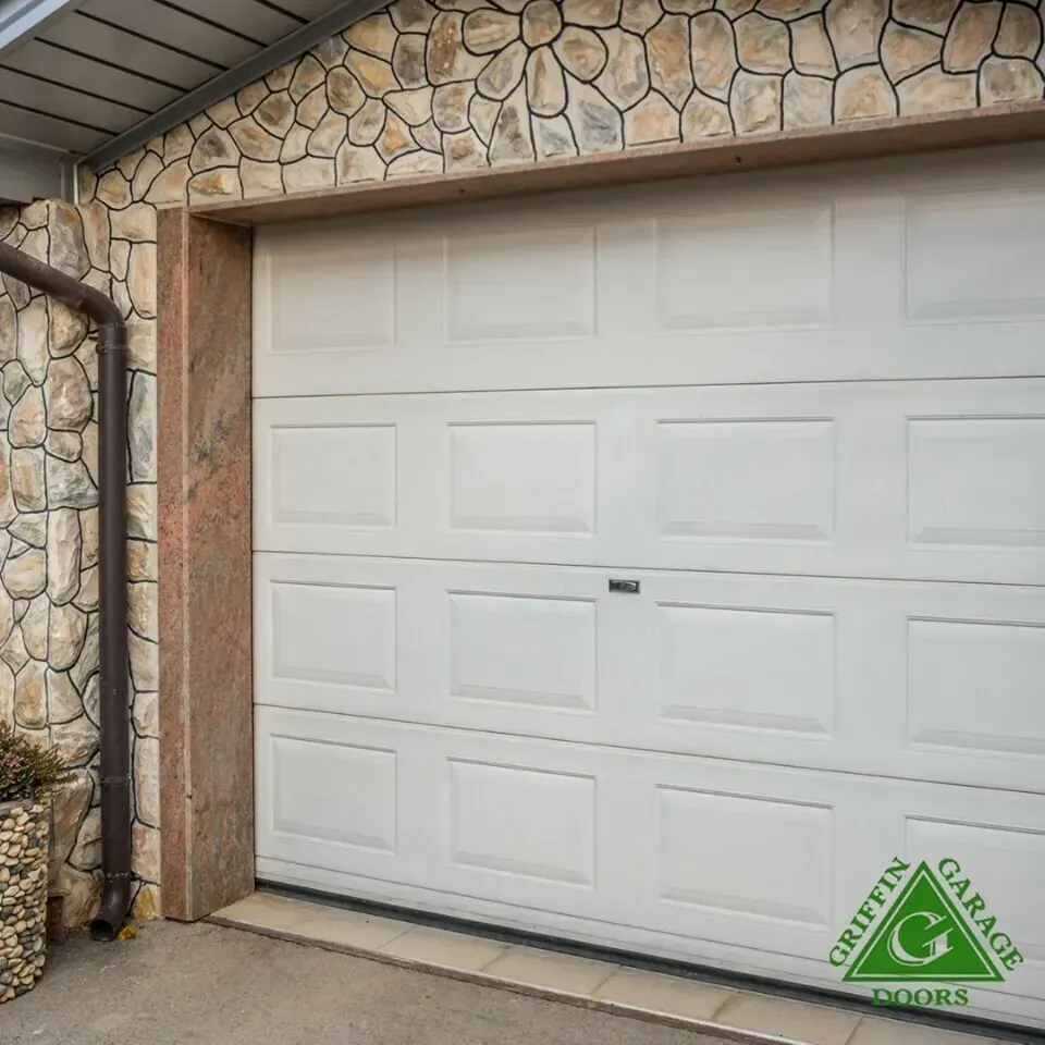 A white garage door with a griffin garage doors logo on it