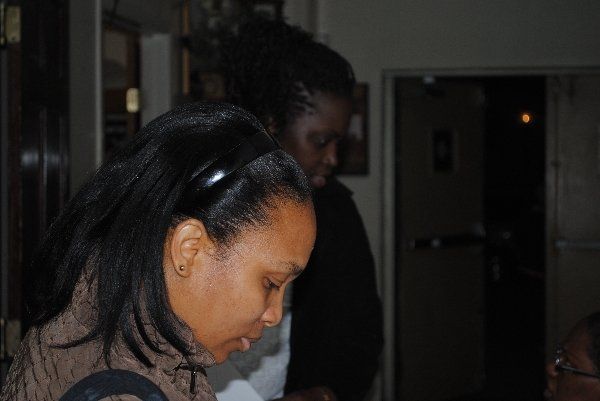 Eastchester Church of God. women are standing next to each other in a dark room