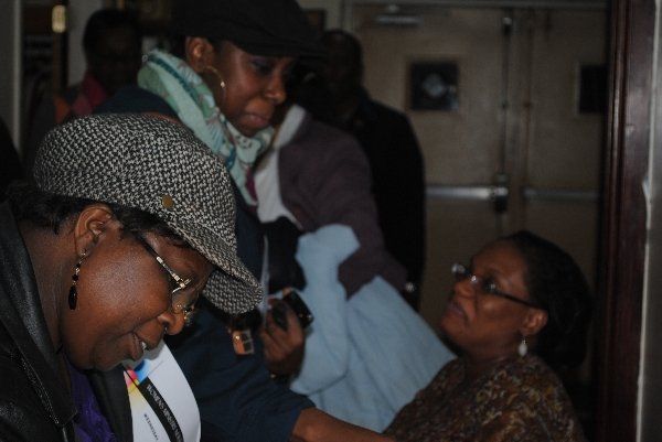 Eastchester Church of God. woman wearing a hat is talking to another woman