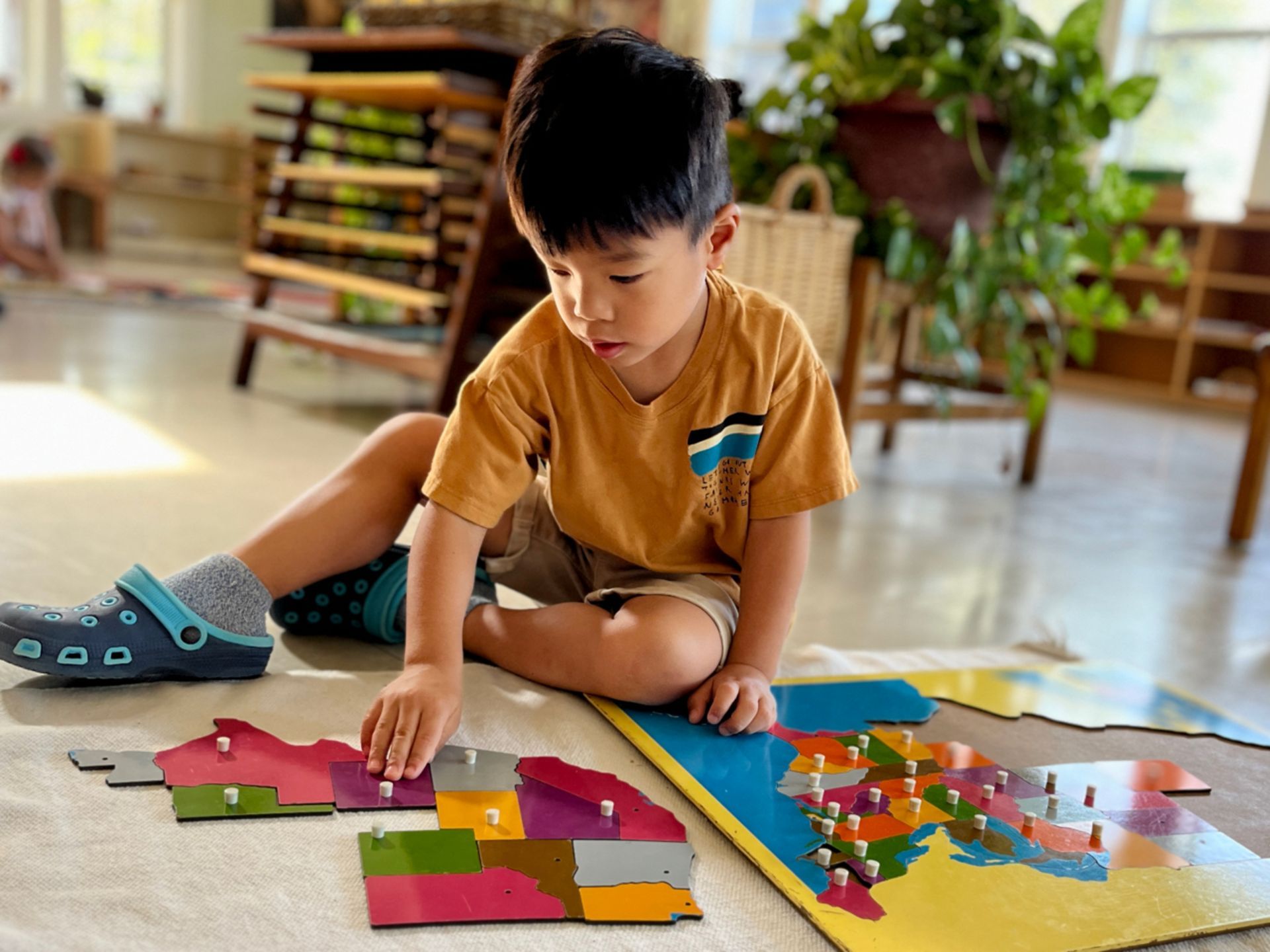 A hild working with Montessori materials