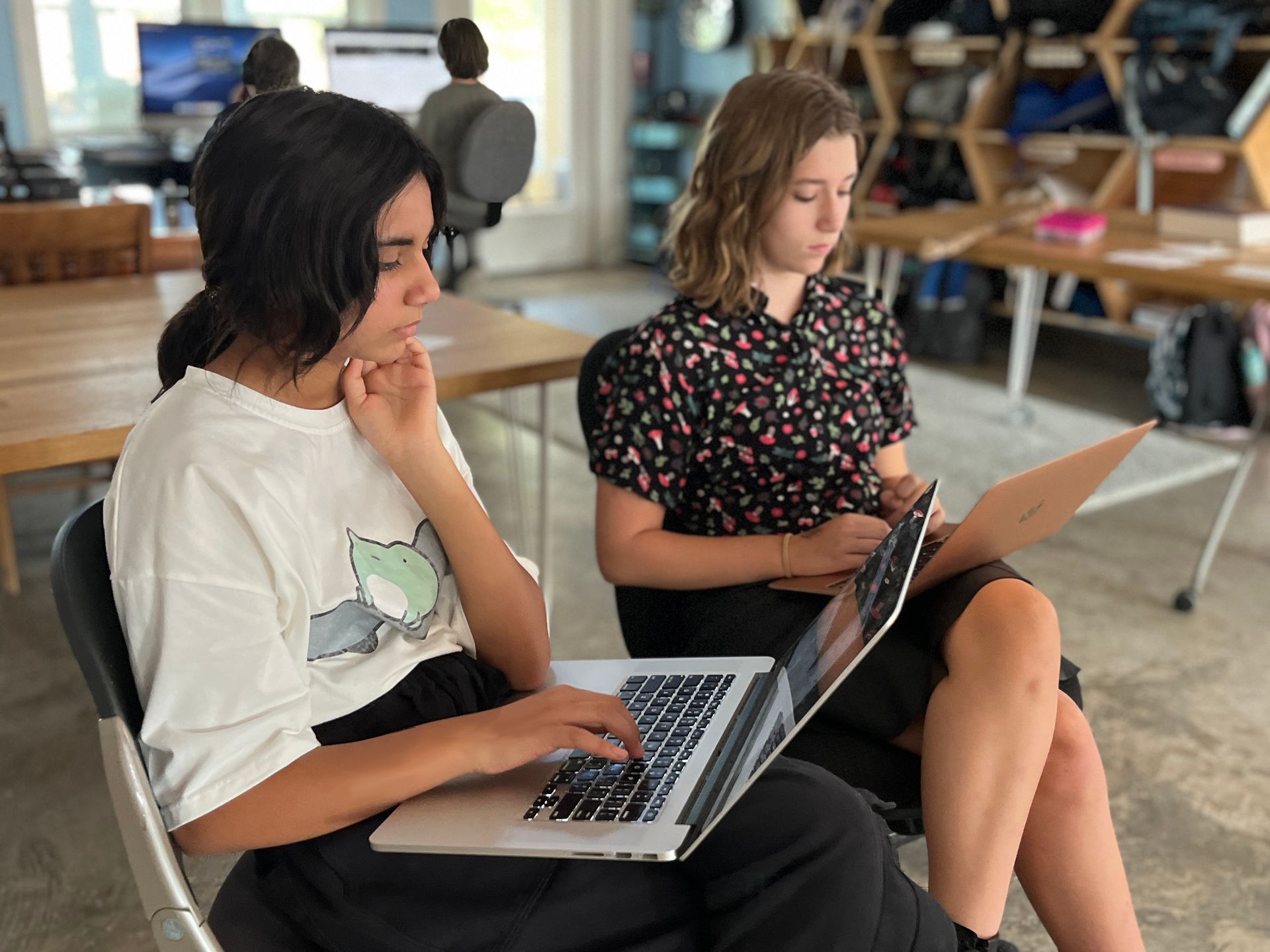 Montessori students using a laptop