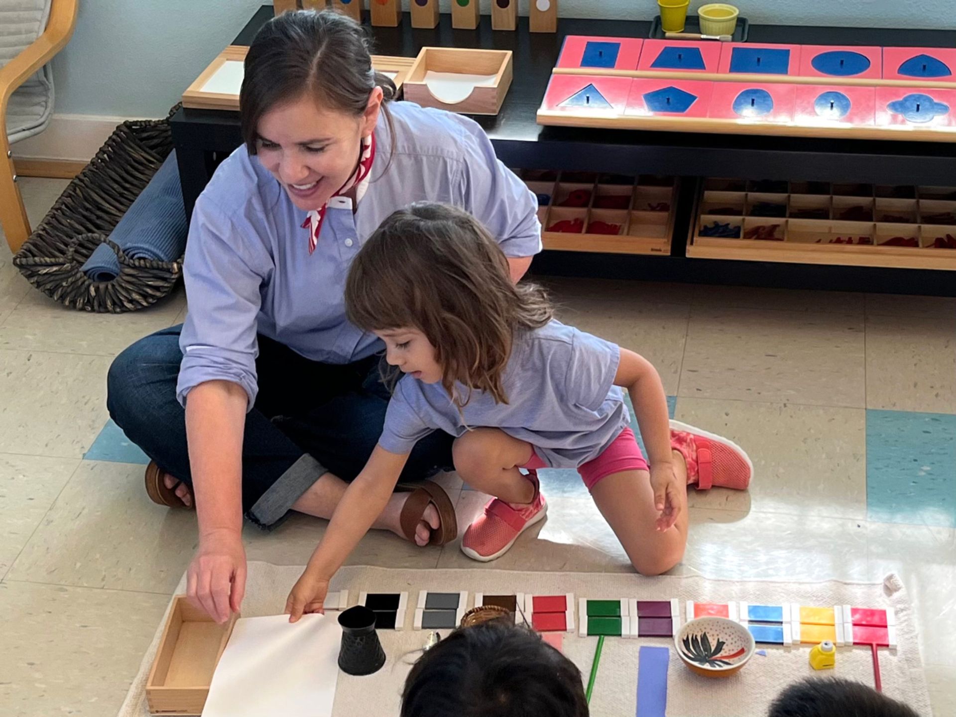 Montessori guide with child