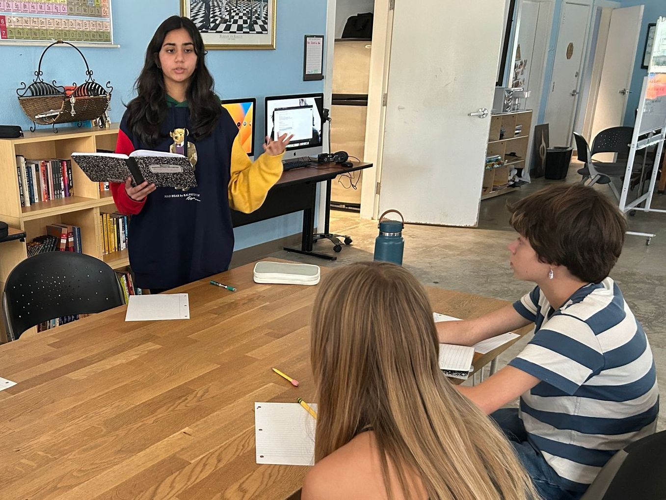 Montessori students using a laptop