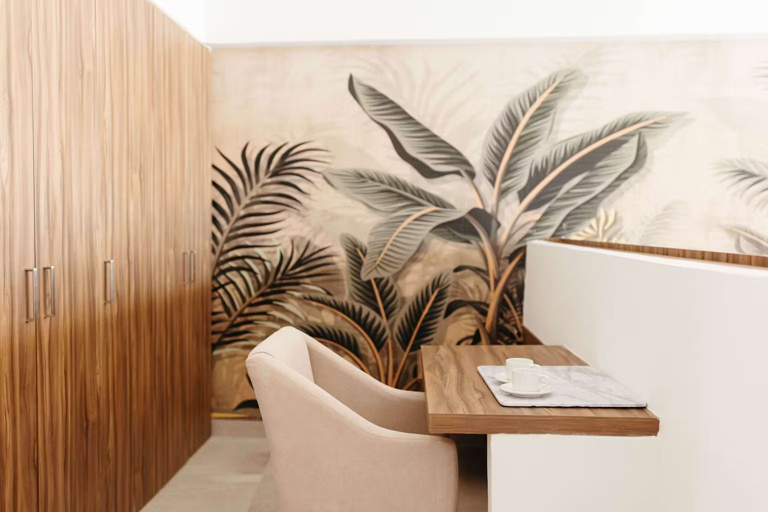 A room with a table and chairs and a painting on the wall.