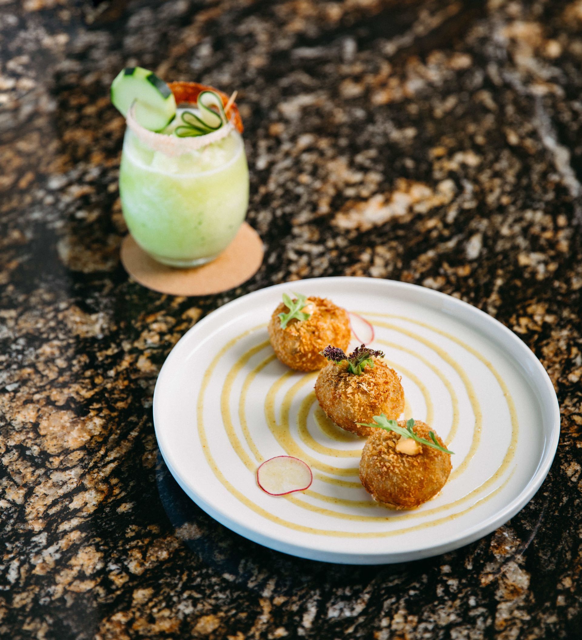 A plate of food and a drink on a table