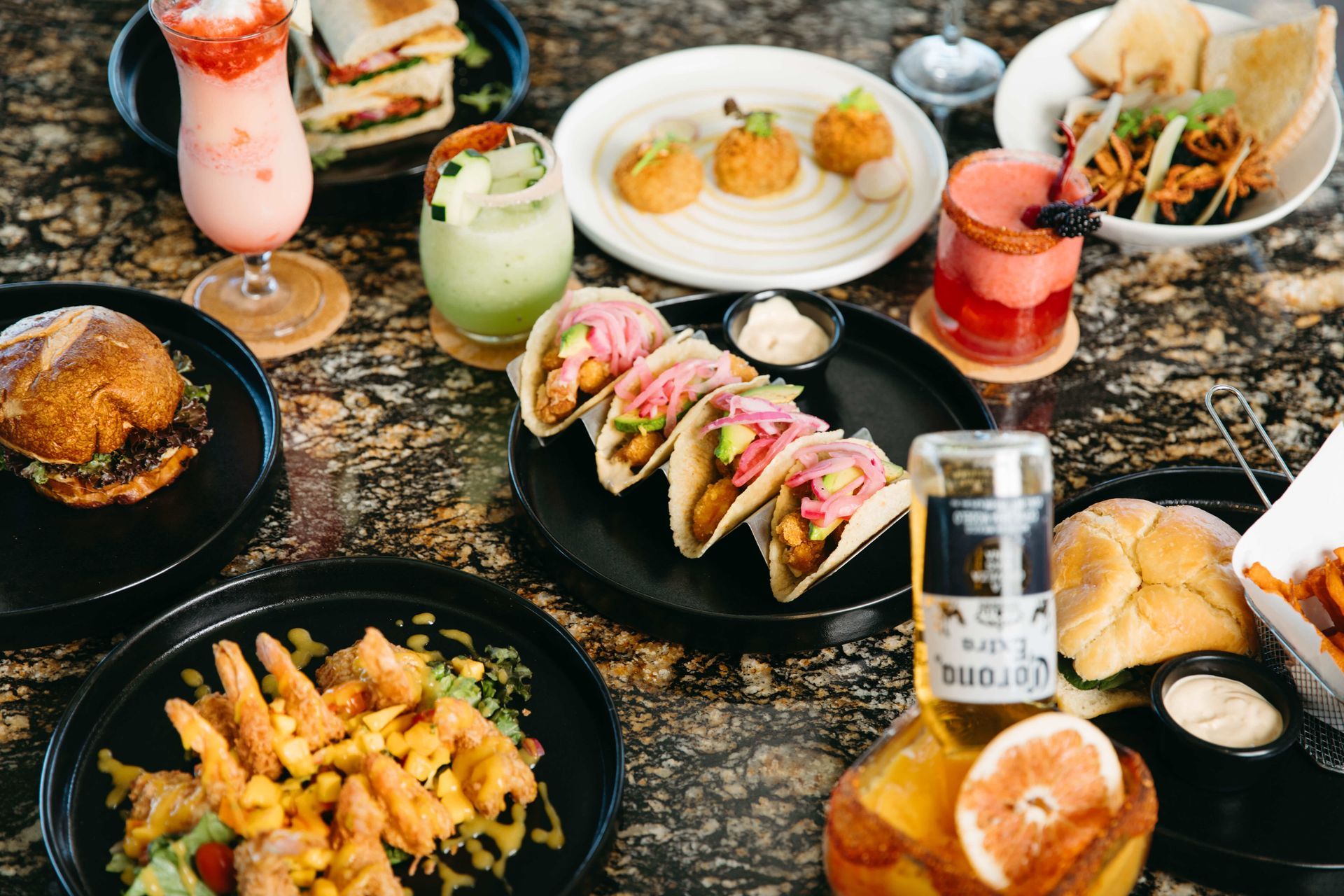 A table topped with plates of food and drinks.
