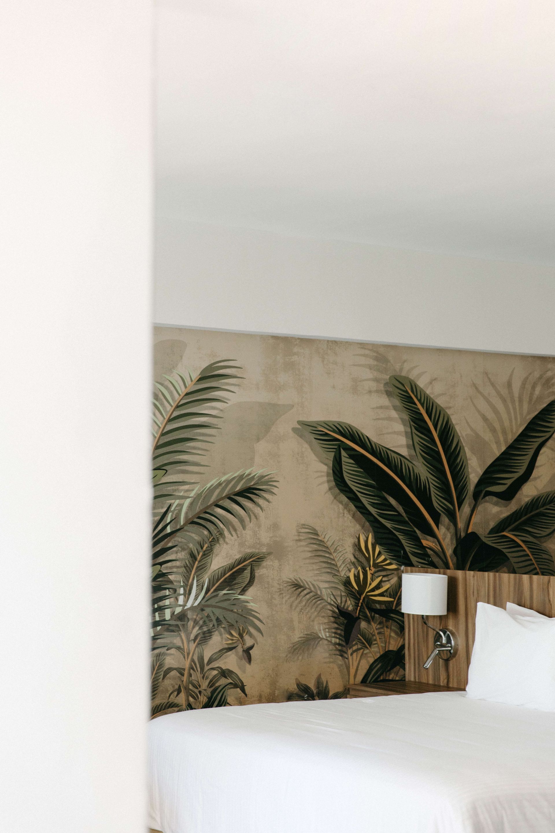 A bedroom with a bed and a painting on the wall.