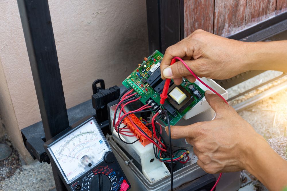 Person Testing Circuit Board With a Multimeter — Big Electrics in Cairns, QLD