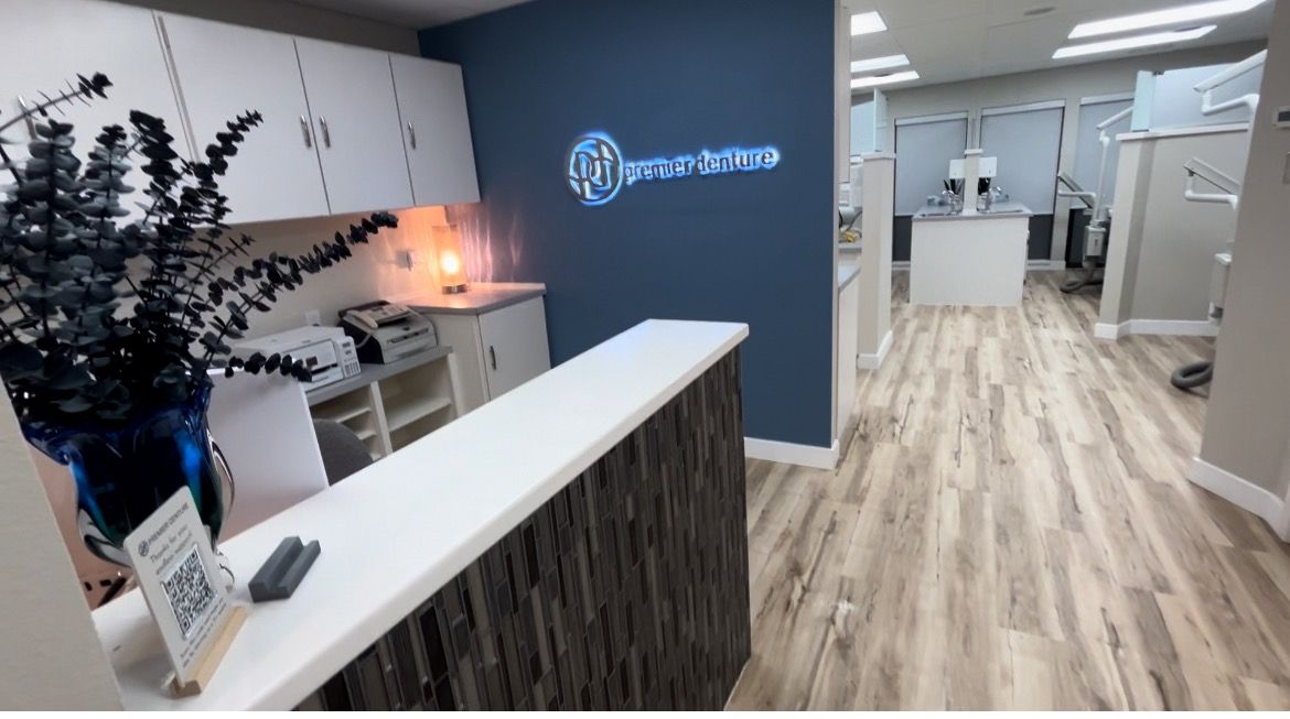 Reception desk in an office setting, with a work area in the background and natural light from skylights.