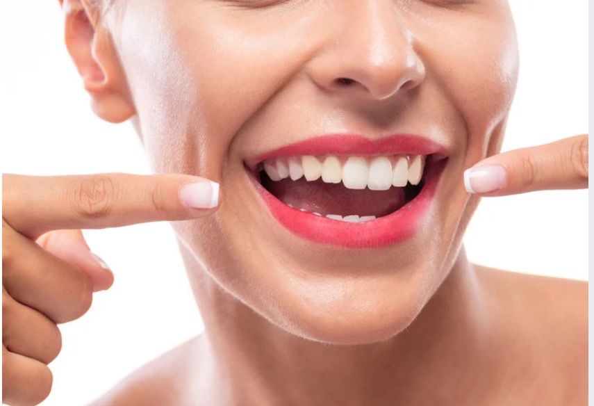 Smiling older adult with white hair, looking to the side.